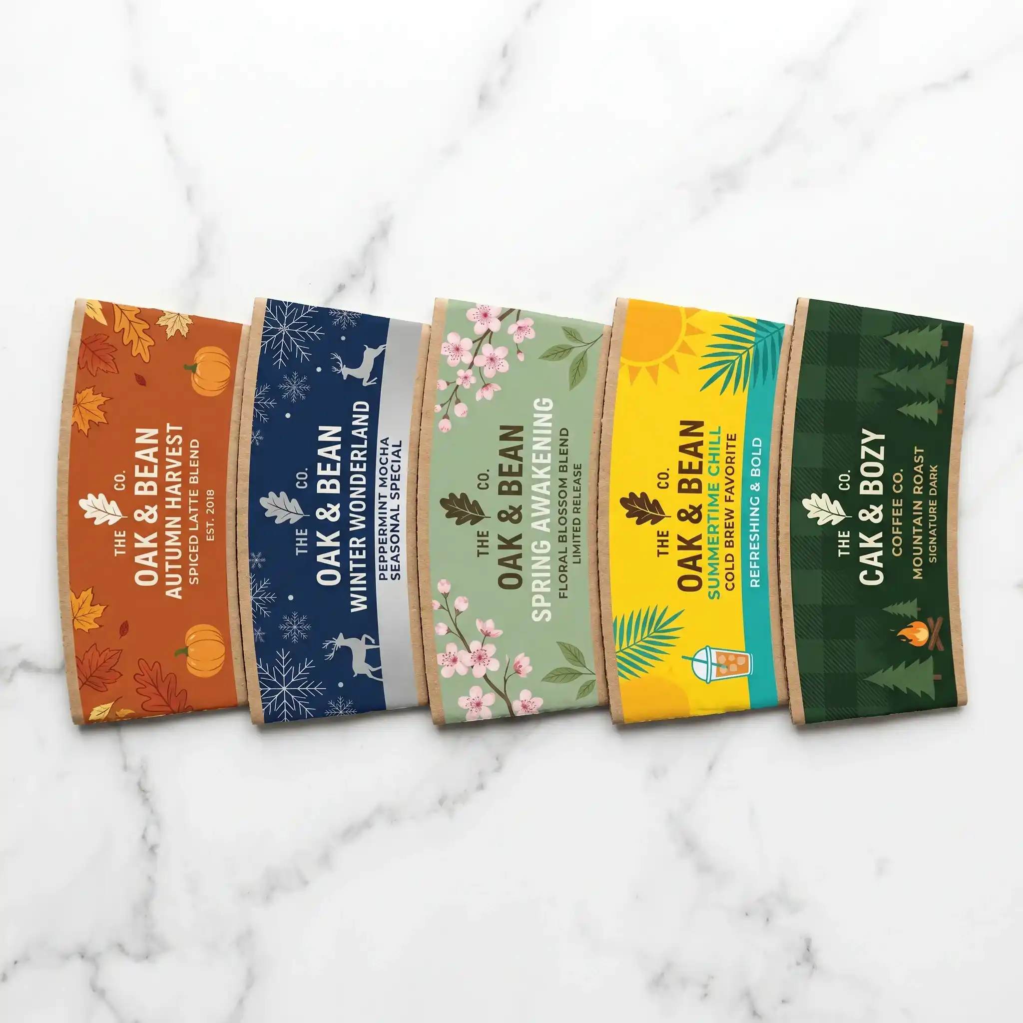 Five seasonal coffee packaging boxes displaying autumn harvest, winter wonderland, spring awakening, summer chill, and mountain roast blends on mar...