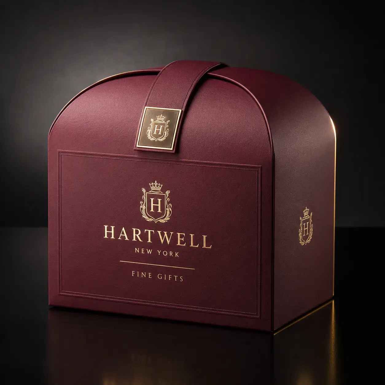 Luxury burgundy gift box with gold foil Hartwell New York branding, arched dome lid, heraldic crest, premium packaging design