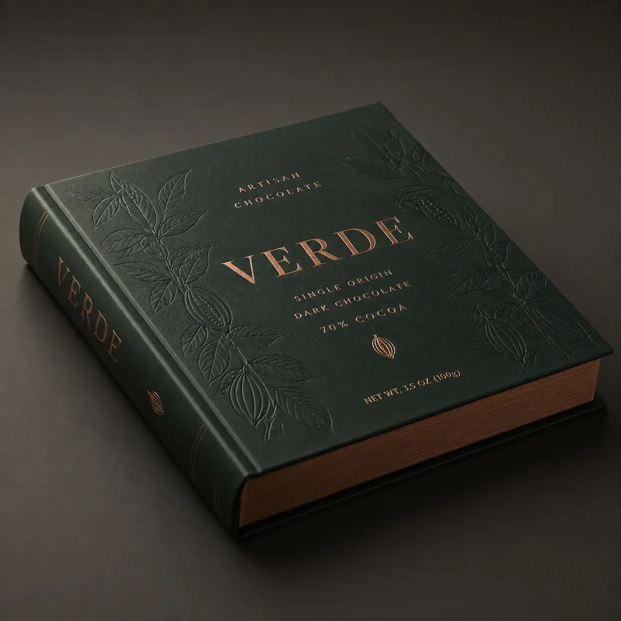 Verde artisan dark chocolate 70% cocoa luxury book-style packaging in deep green with copper foil embossed cacao leaf design