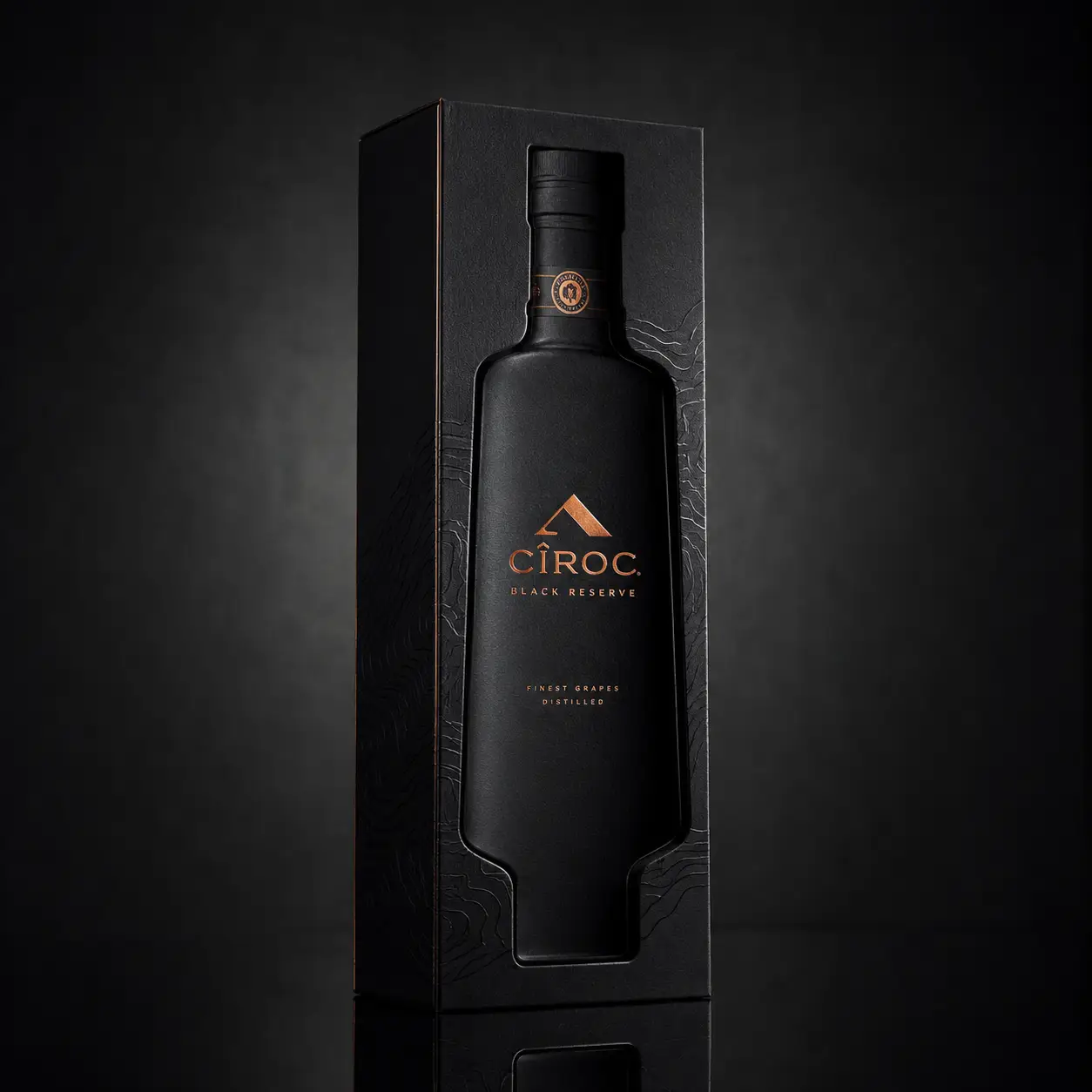 Cîroc Black Reserve vodka matte black bottle with copper branding in luxury gift box packaging, dark moody product photography