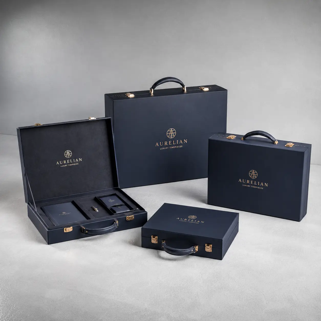 Navy blue Aurelian Luxury Timepieces briefcase gift boxes with gold hardware and logo, premium watch packaging set