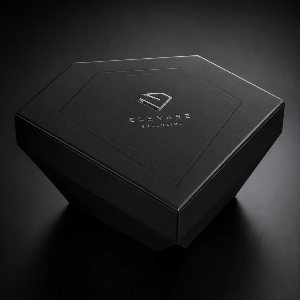 Matte black luxury gift box with silver embossed Elevare Exclusive logo, premium rigid packaging, dark moody studio photography