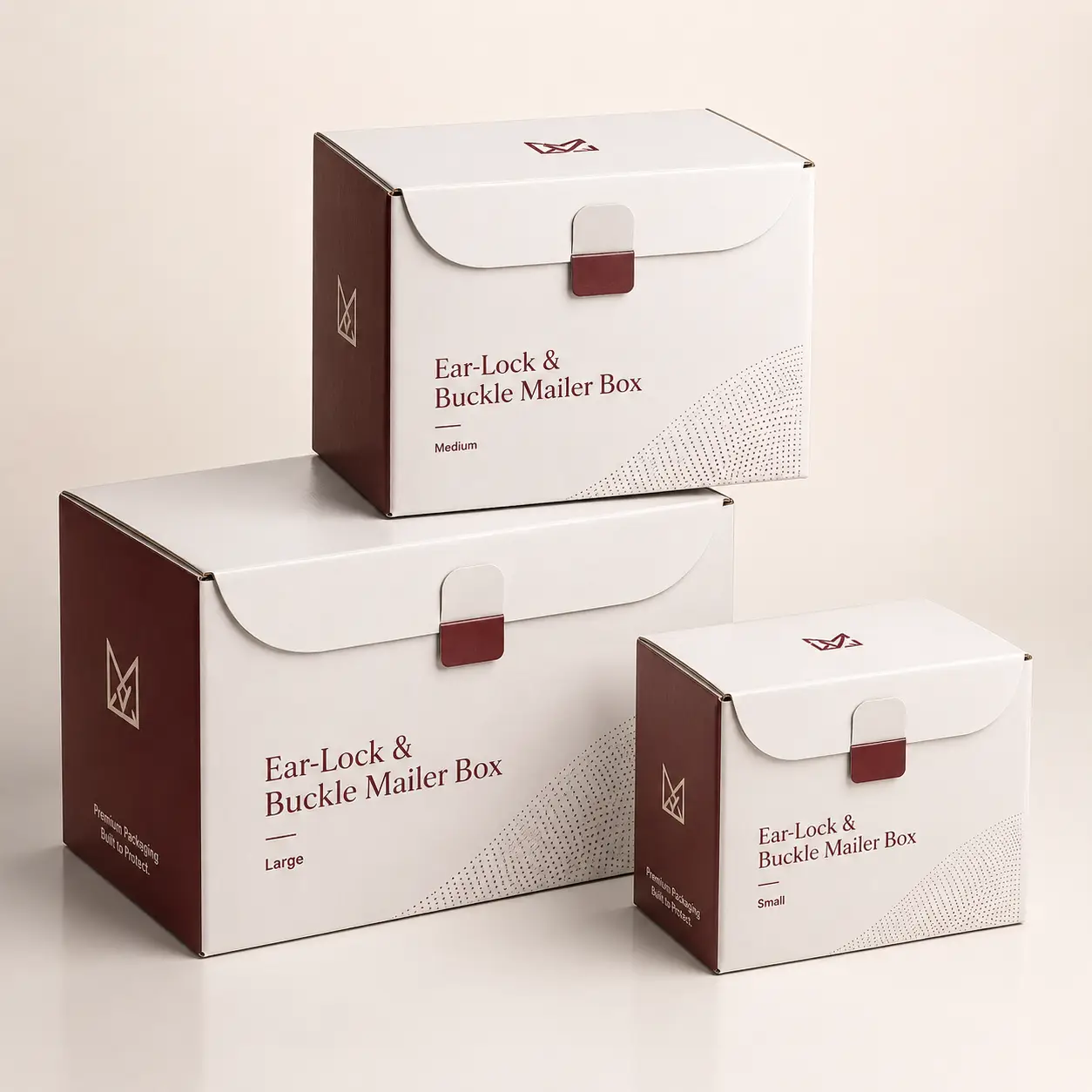 Three white and burgundy Ear-Lock & Buckle Mailer Boxes in small, medium, and large sizes stacked elegantly on neutral background