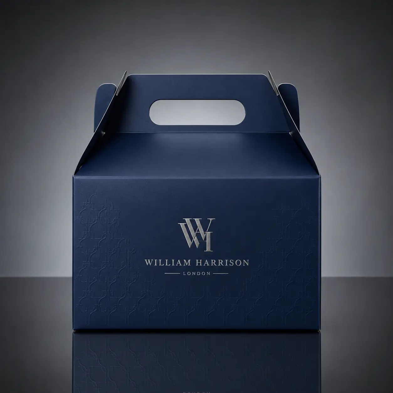 Navy blue luxury gable gift box with silver William Harrison London monogram logo, embossed pattern, premium branded packaging