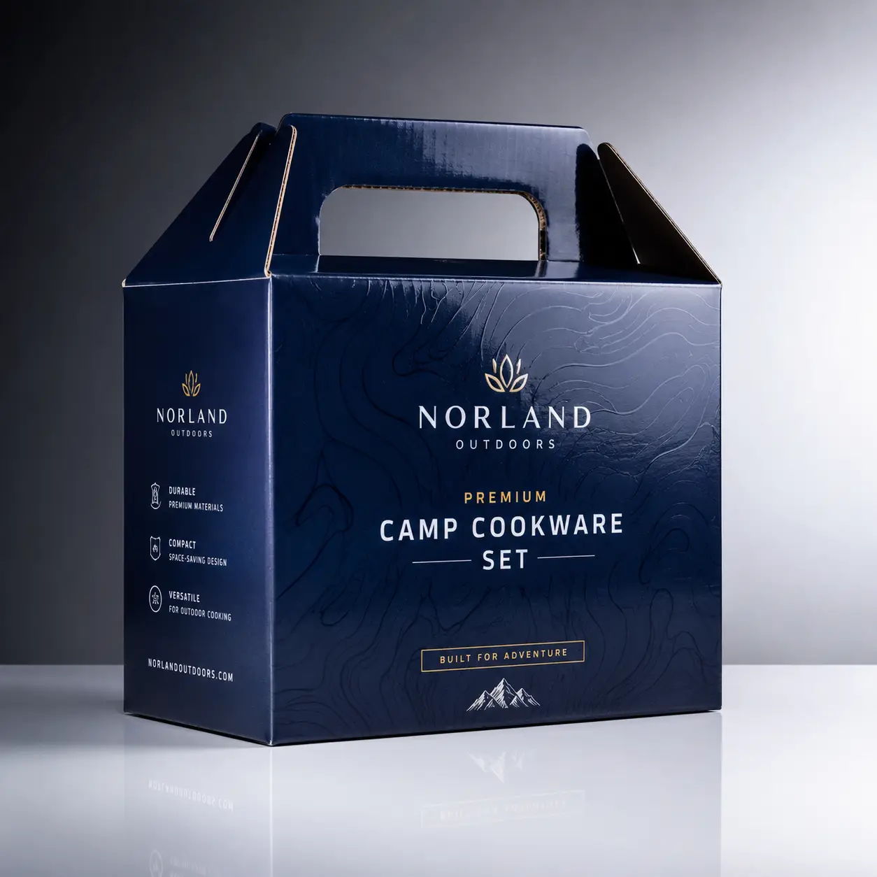Navy blue premium camp cookware set box by Norland Outdoors with gold typography, carry handle, mountain graphic, built for adventure