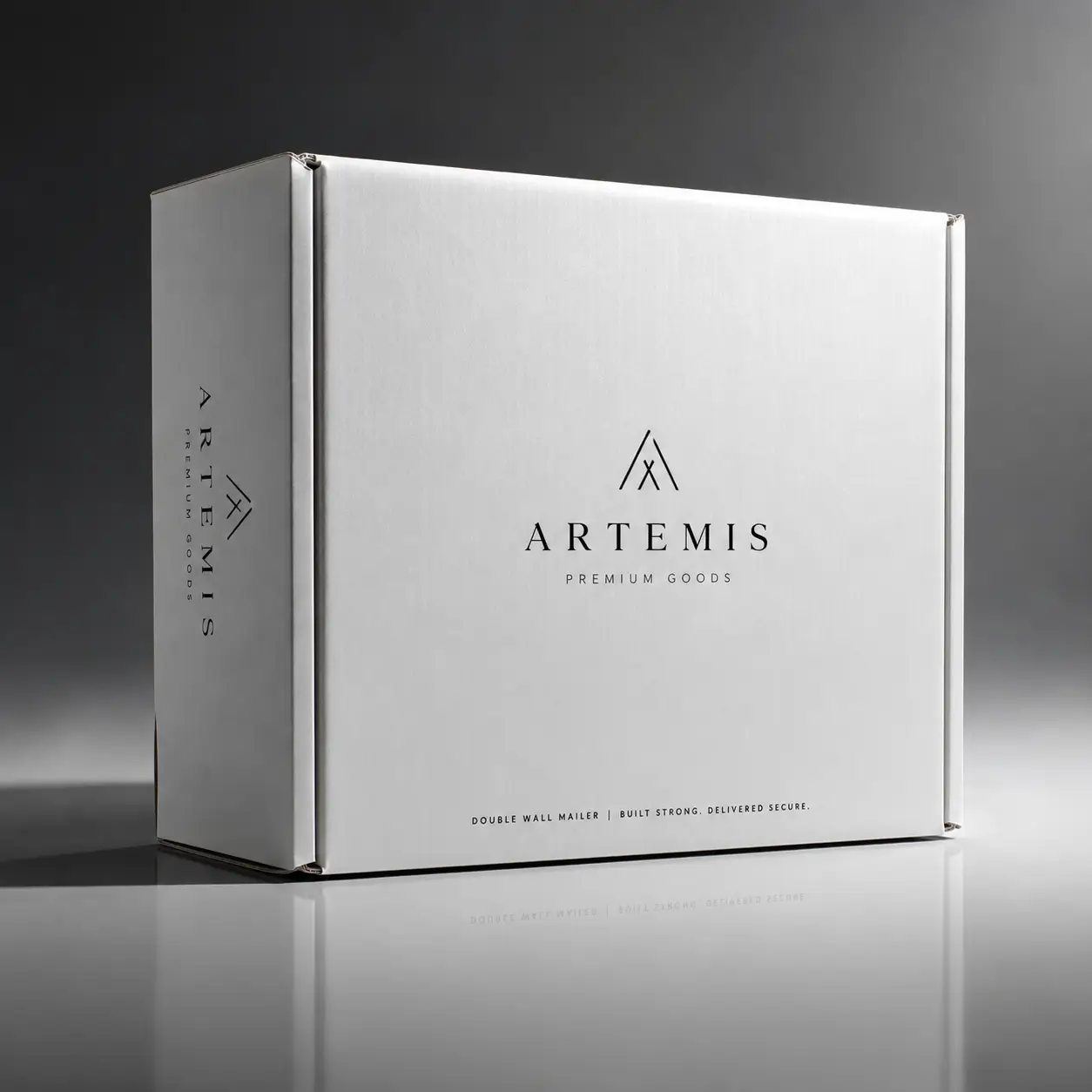 White corrugated double wall mailer box with Artemis Premium Goods logo, sleek minimalist luxury packaging on reflective surface