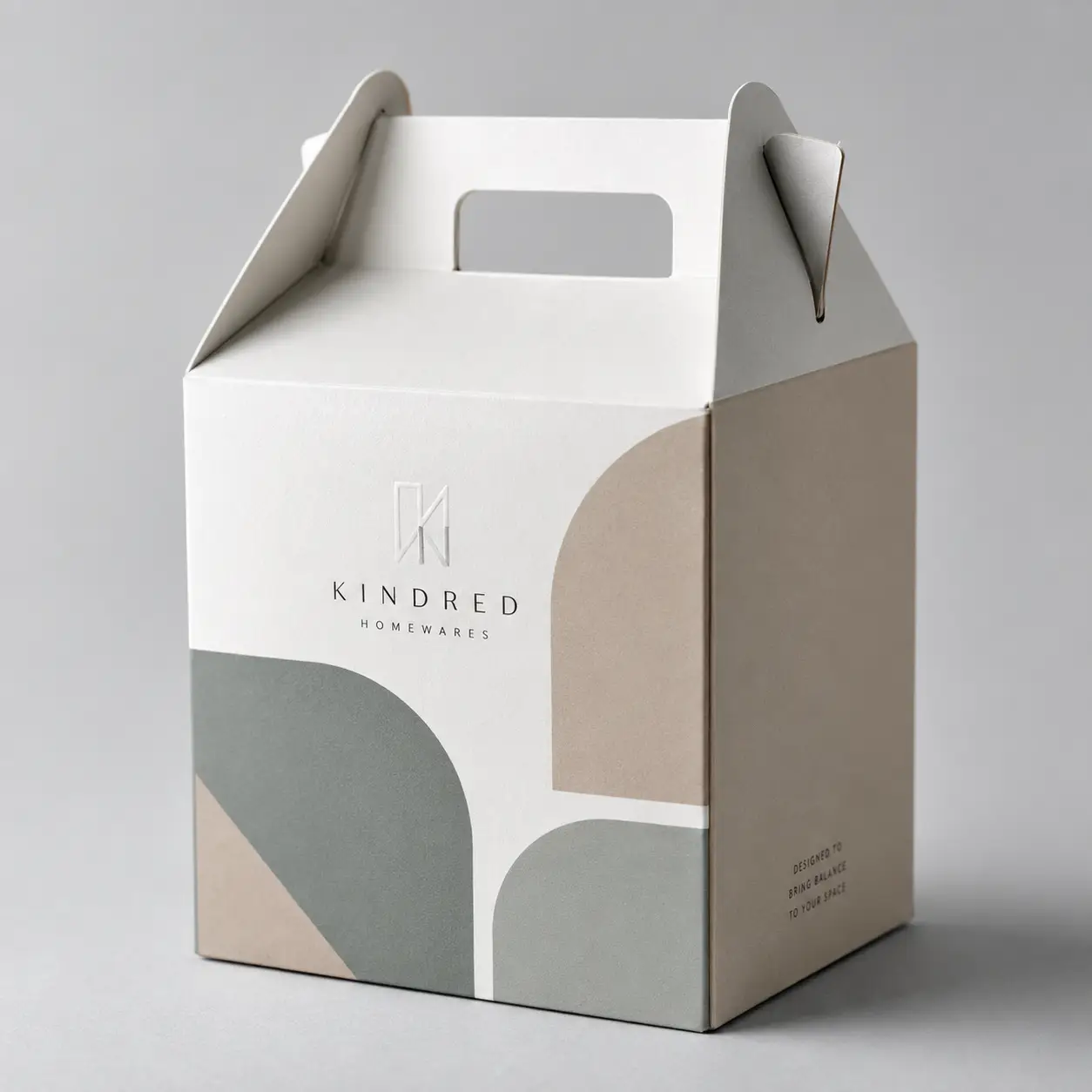 Kindred Homewares gable gift box packaging with sage green beige geometric shapes white cardboard handle elegant minimalist design