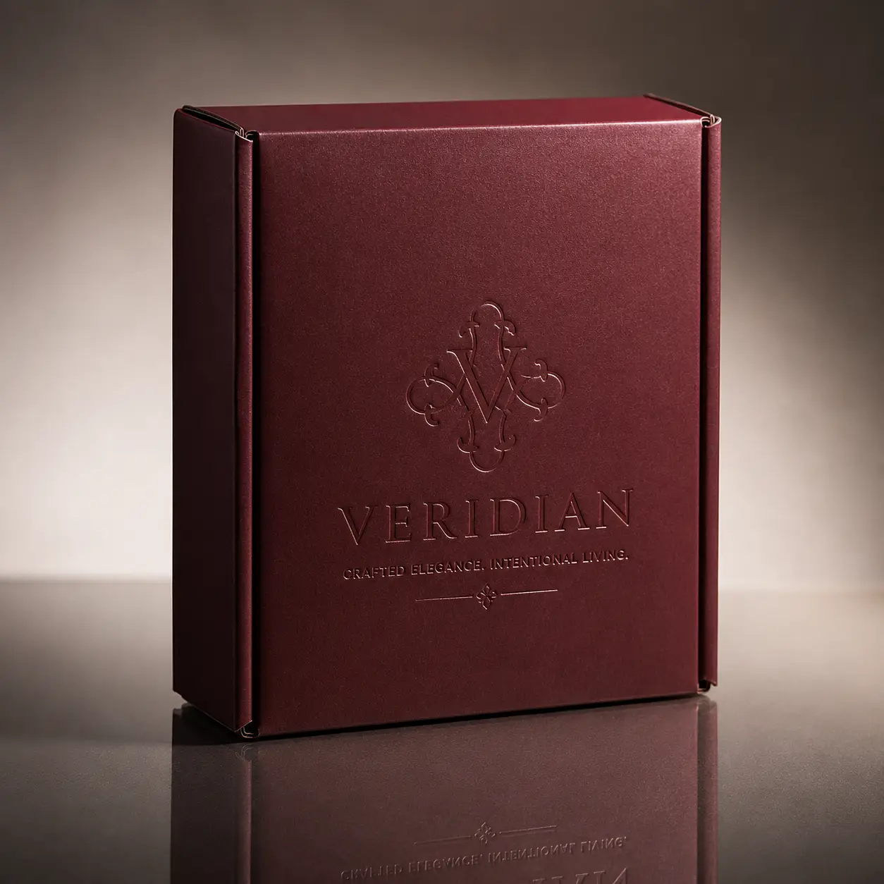 Veridian luxury deep burgundy gift box with embossed logo and tagline Crafted Elegance Intentional Living premium packaging design