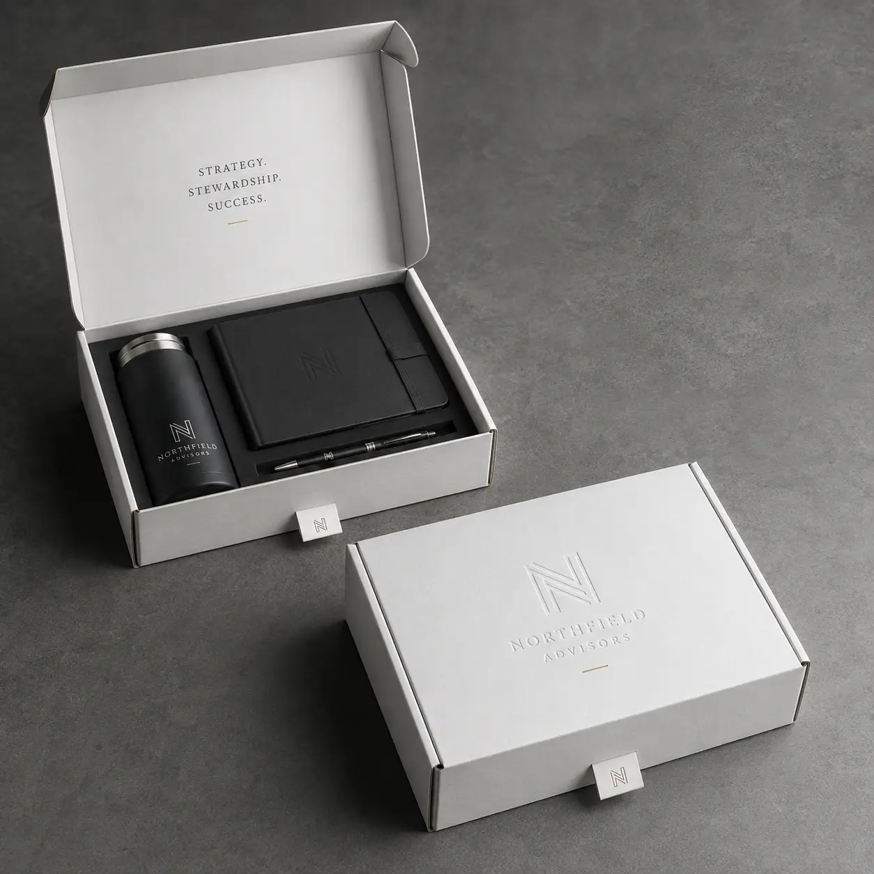 Northfield Advisors luxury branded gift box set with black tumbler, notebook, and pen in white custom packaging