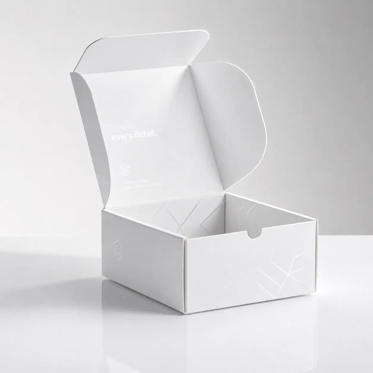 White open mailer box with geometric embossed design, premium custom packaging, elegant minimal branding, matte finish, studio light