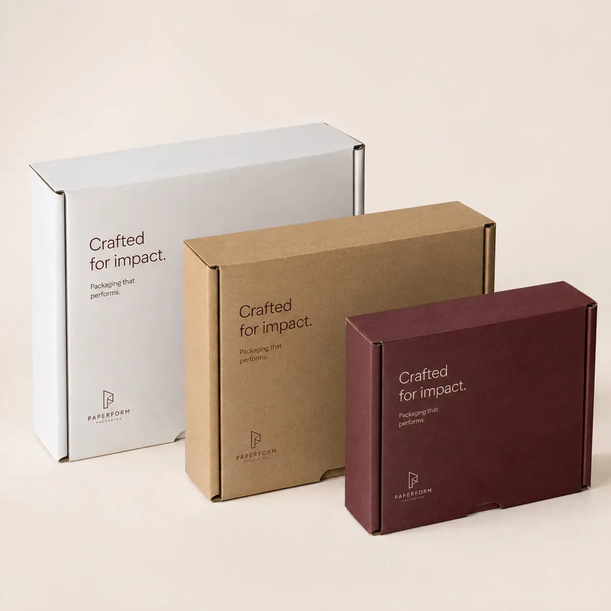 Three custom mailer boxes in white, kraft, and burgundy with Crafted for Impact branding by Paperform Packaging