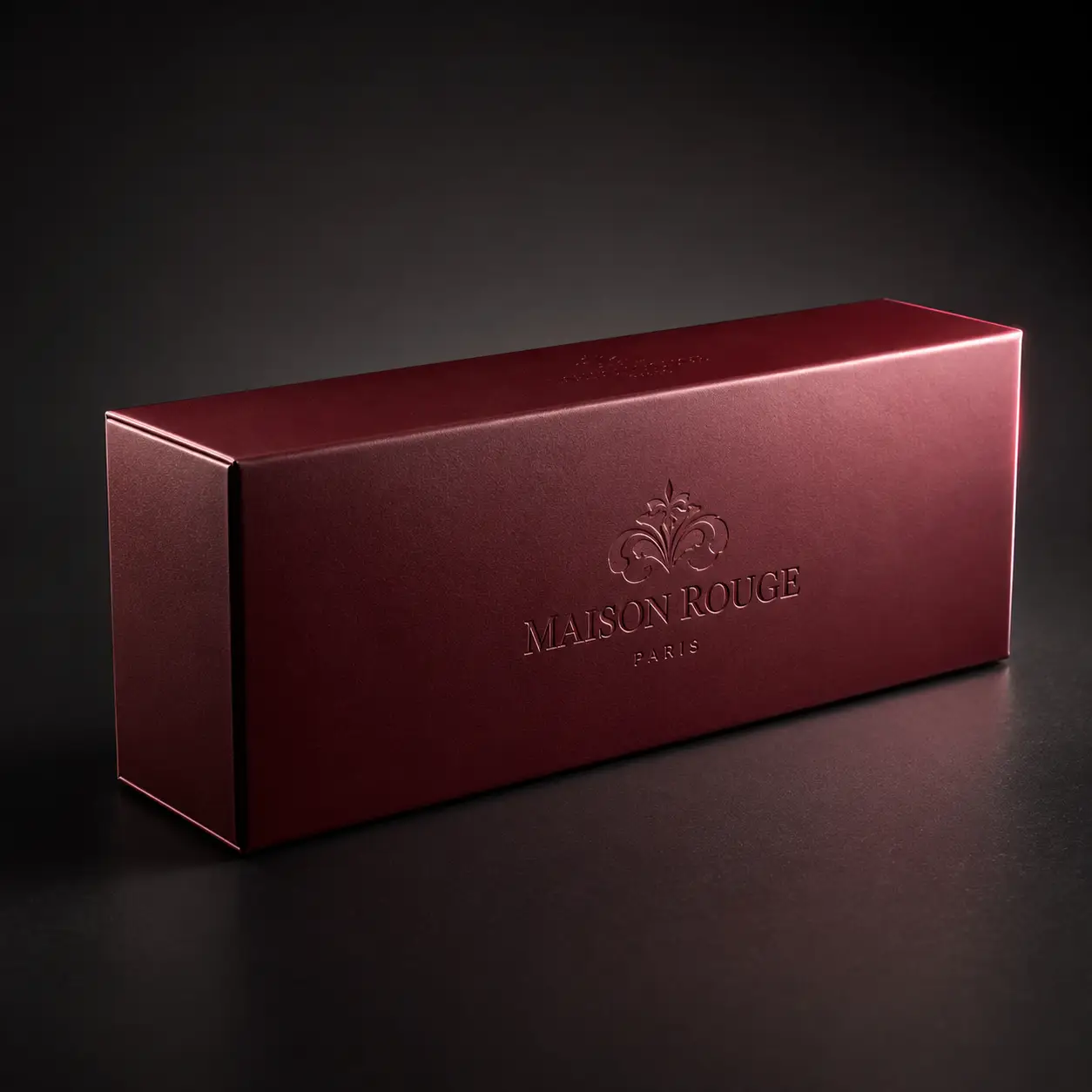 Elegant deep burgundy luxury gift box with embossed Maison Rouge Paris logo, premium brand packaging design on dark background