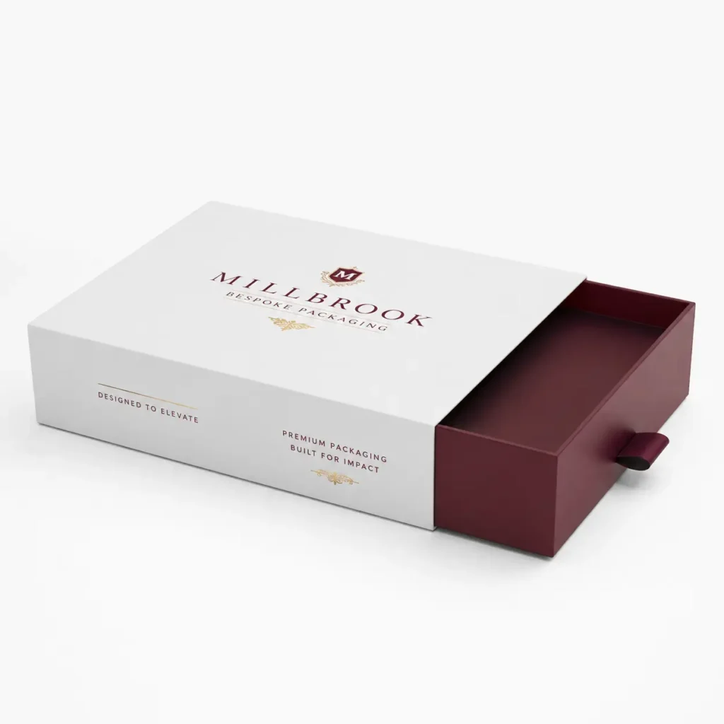 Luxury white and burgundy drawer slide gift box with Millbrook Bespoke Packaging gold branding, premium rigid packaging design
