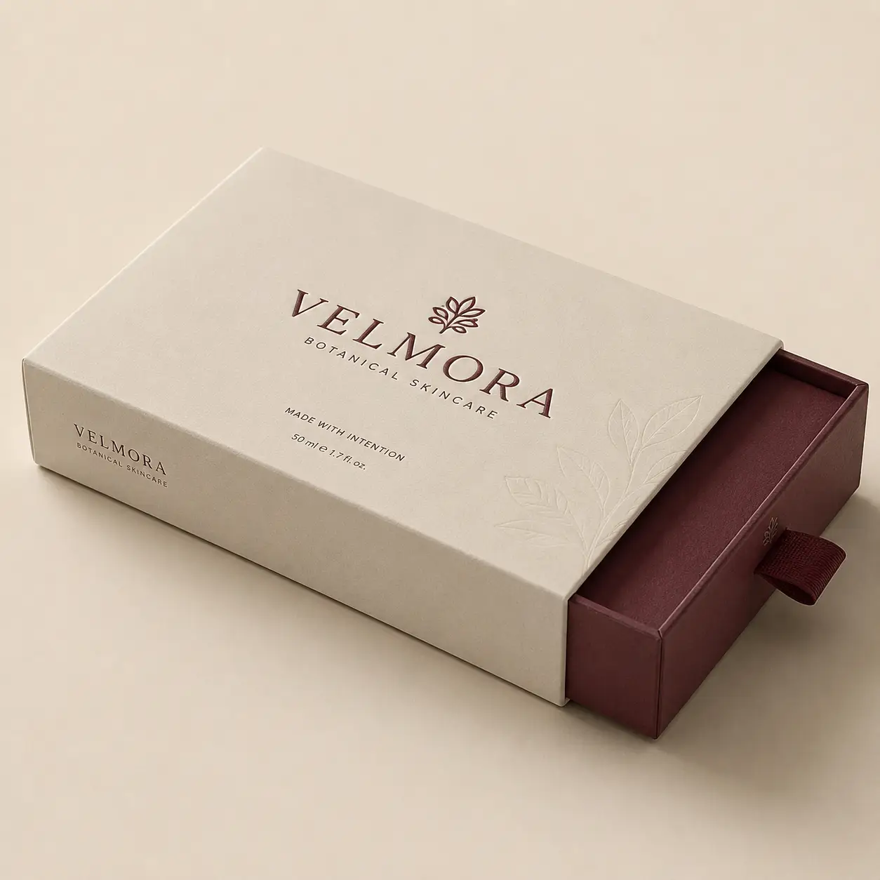 Velmora Botanical Skincare luxury drawer gift box in cream and burgundy with embossed botanical design, 50ml skincare packaging