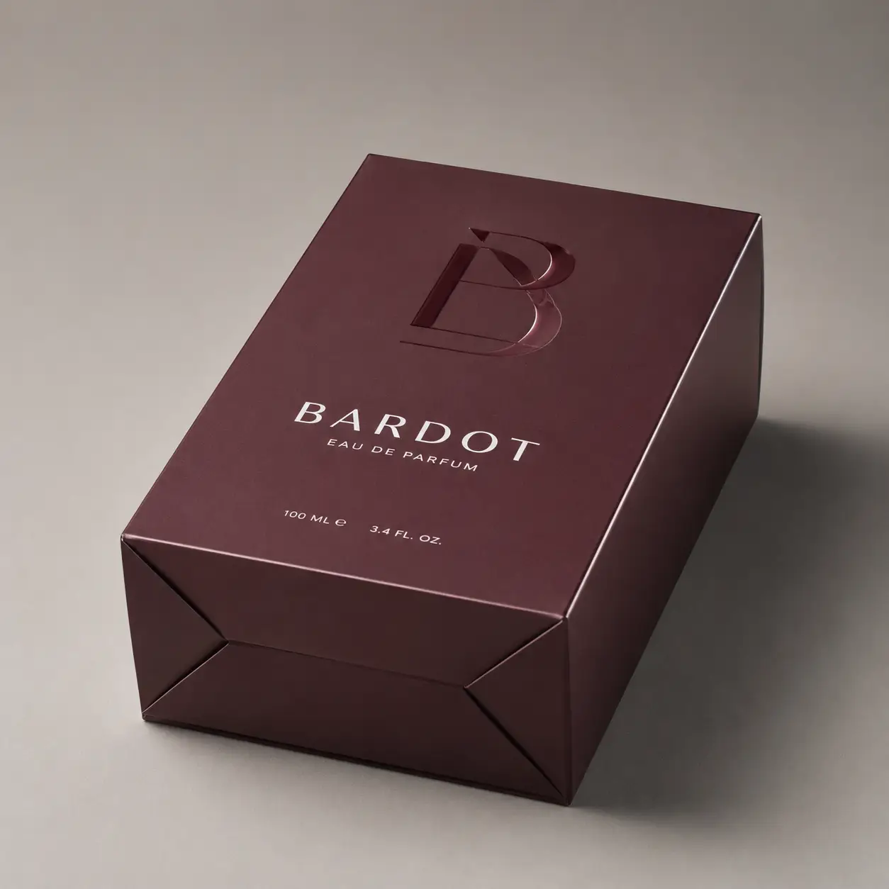 Bardot Eau de Parfum 100ml luxury perfume box in deep burgundy with embossed B logo, elegant premium fragrance packaging design