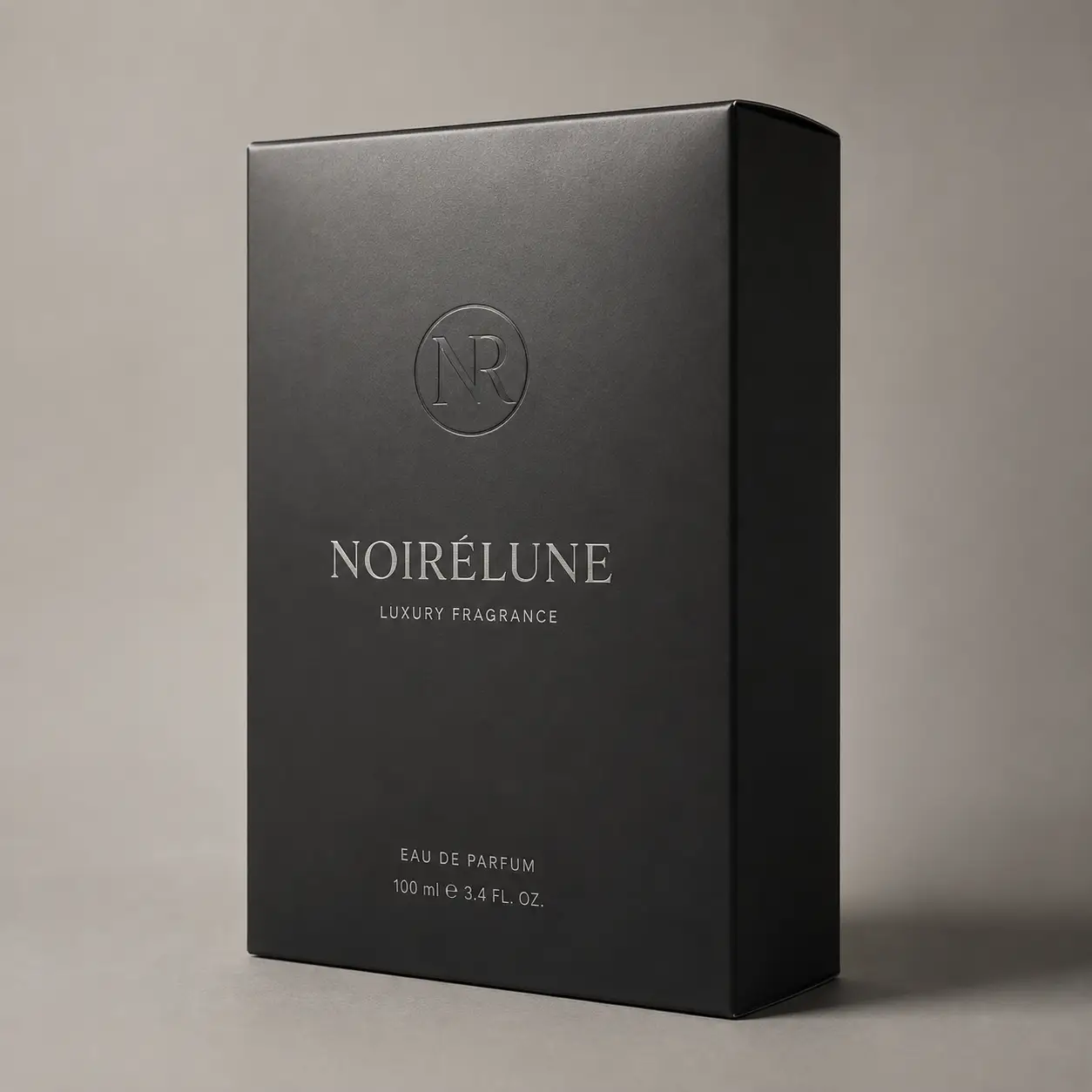 Matte black luxury perfume box packaging for Noirelune Eau de Parfum 100ml with silver embossed logo on gray background