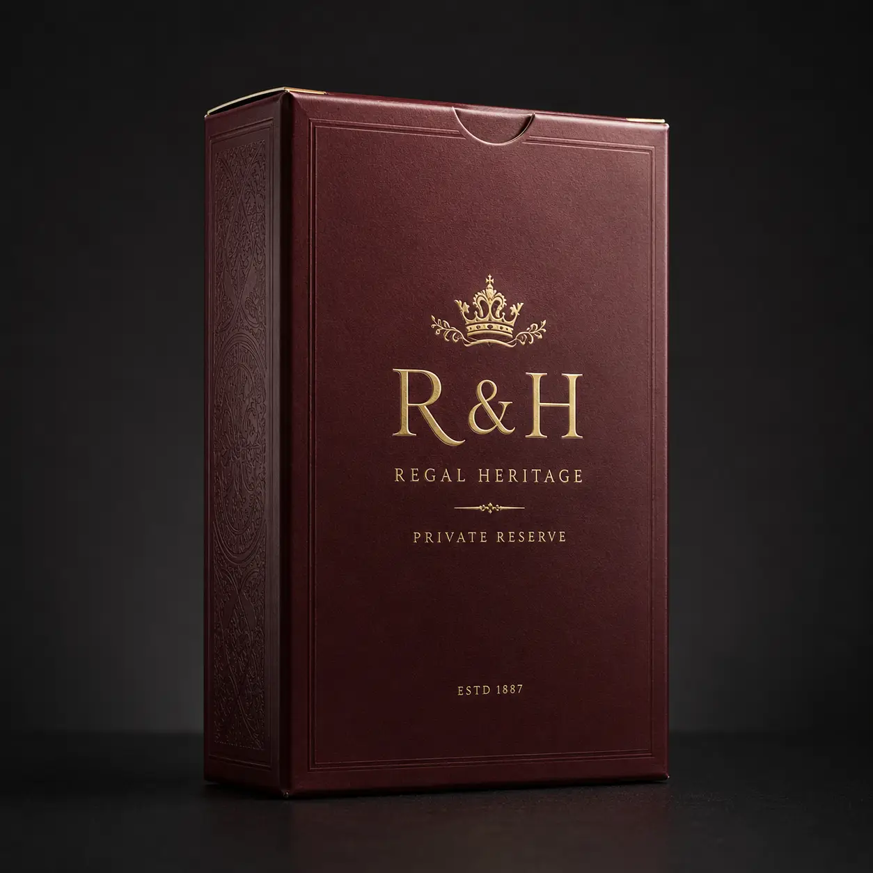 Luxury burgundy gift box with gold foil R&H Regal Heritage Private Reserve branding and crown logo, ESTD 1887, premium packaging design