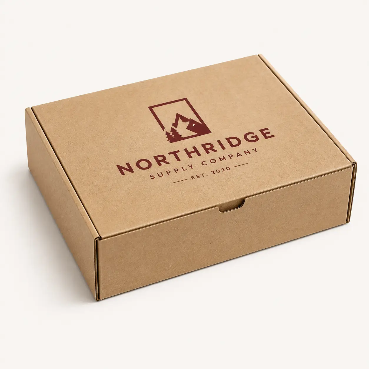Kraft brown custom mailer box printed with dark red Northridge Supply Company logo, mountains and pine trees design, est. 2020