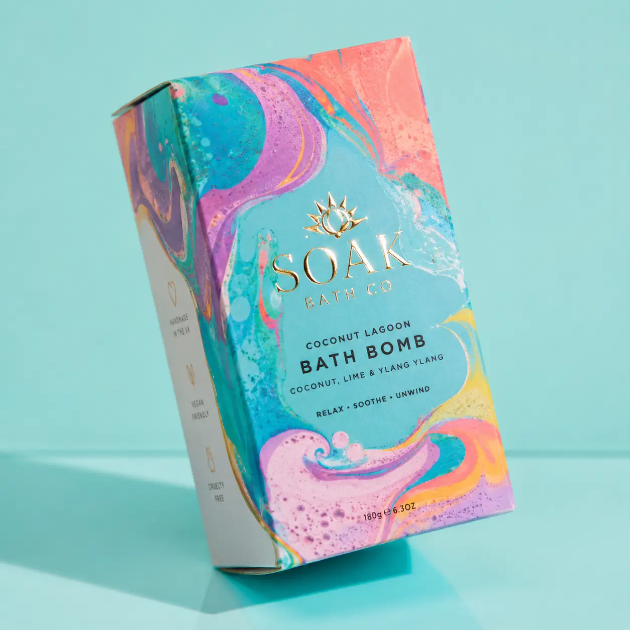 Soak Bath Co Coconut Lagoon Bath Bomb box with vibrant swirling pink teal coral marbled packaging design, vegan cruelty-free product