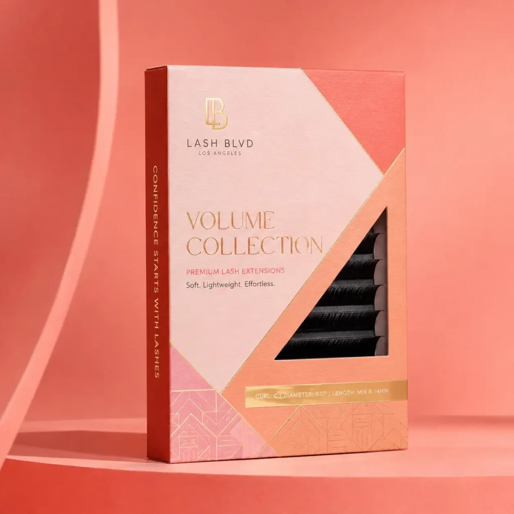 Lash BLVD Los Angeles Volume Collection premium lash extensions box in pink, coral, and gold tones on coral background