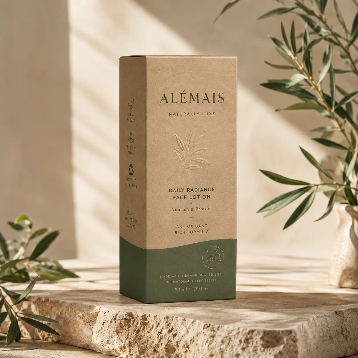 Alémais Naturally Luxe Daily Radiance Face Lotion kraft box with green base on stone, olive branches, clean beauty packaging design