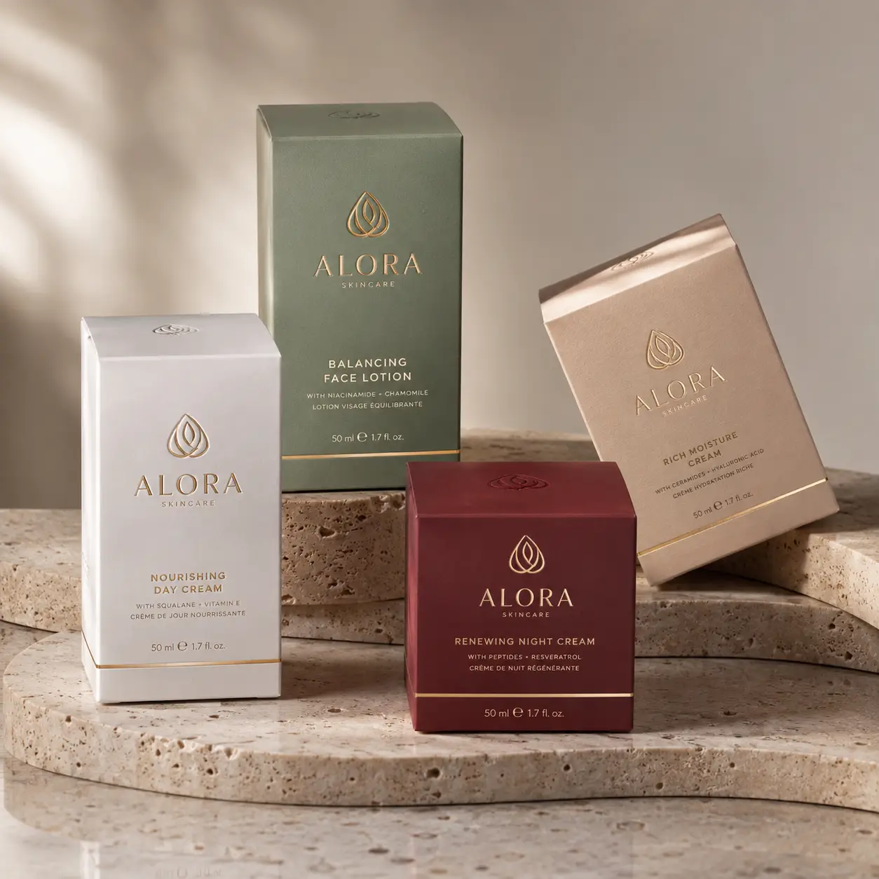 Alora Skincare luxury packaging set featuring white day cream, green face lotion, burgundy night cream, and gold moisture cream boxes
