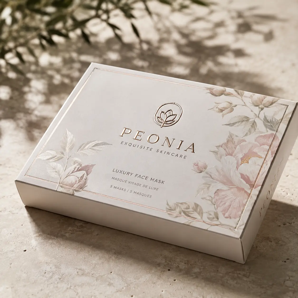 Peonia Exquisite Skincare luxury face mask box, cream floral packaging with rose gold foil text, elegant beauty product design