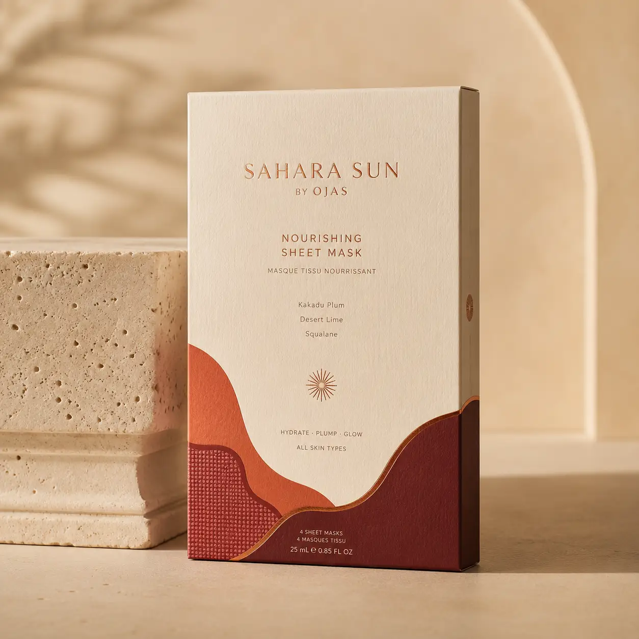 Sahara Sun by Ojas nourishing sheet mask cream box with terracotta desert waves design leaning on travertine stone props