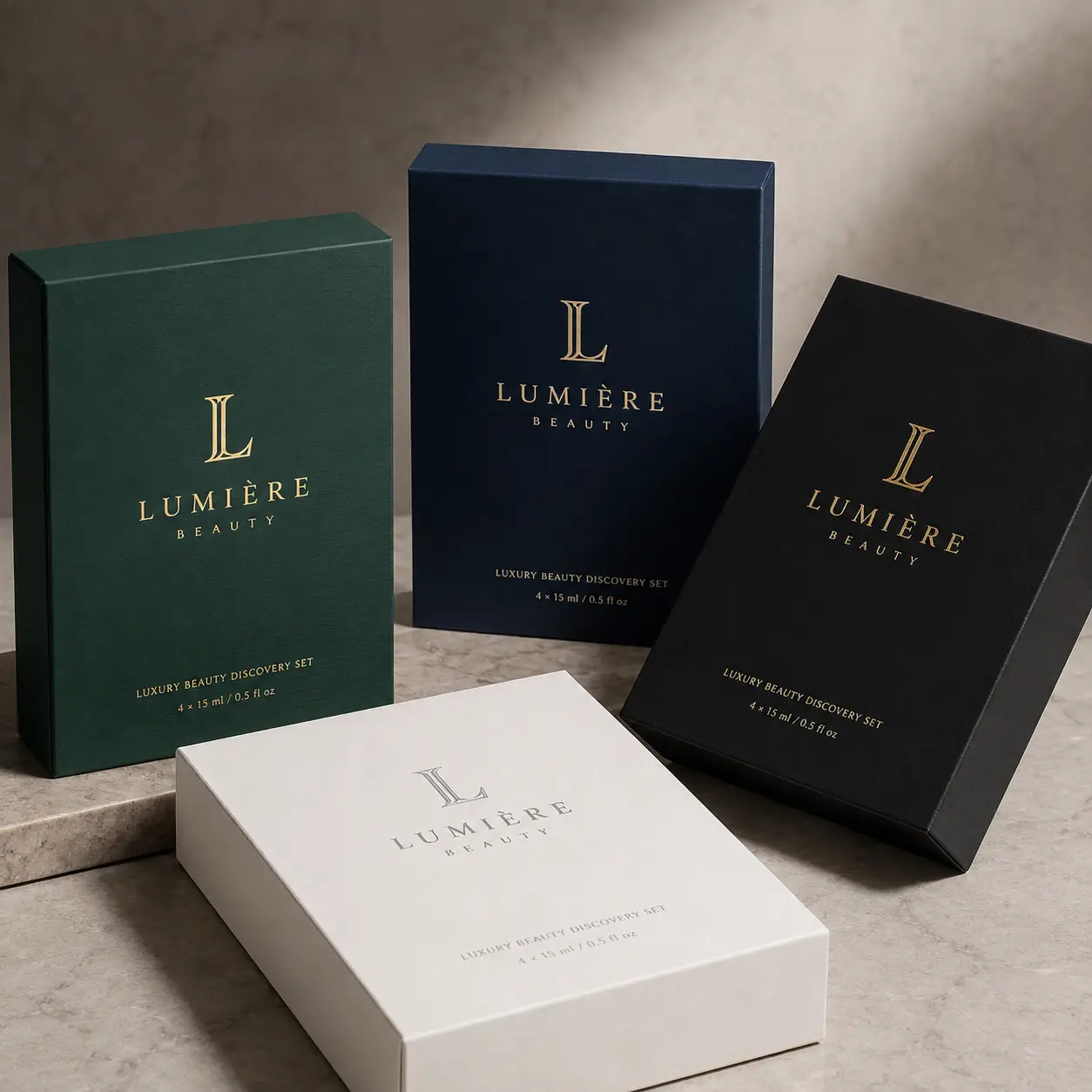 Lumière Beauty luxury gift boxes in forest green, navy, black, and white with gold foil branding on marble surface
