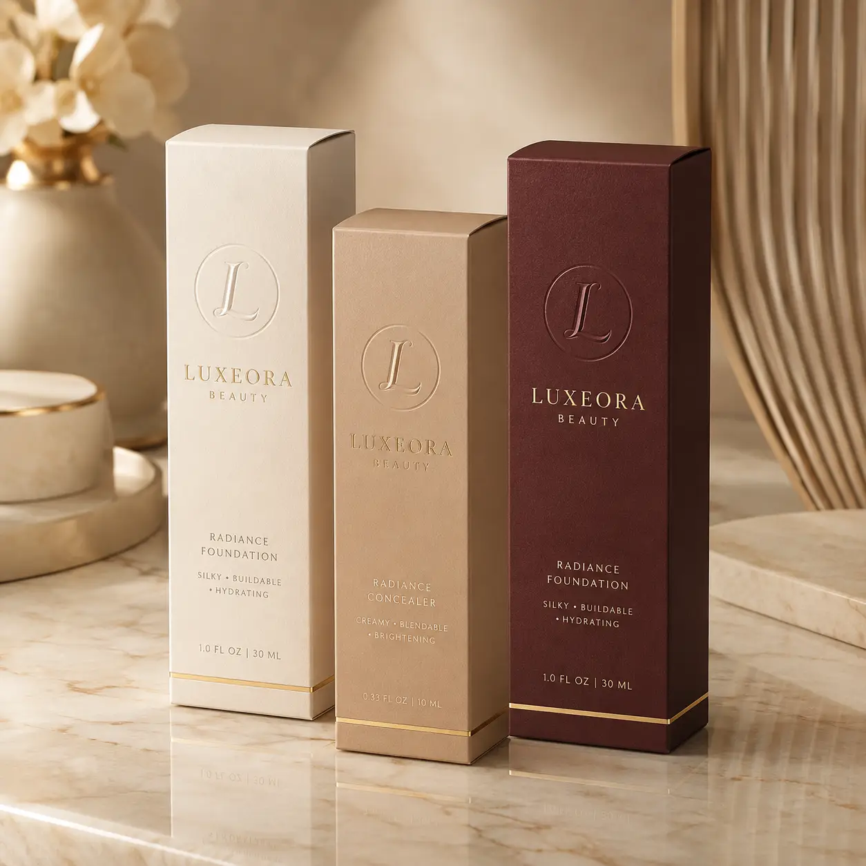 Luxeora Beauty luxury cosmetic packaging boxes in cream, tan, and burgundy displaying Radiance Foundation and Concealer on marble surface