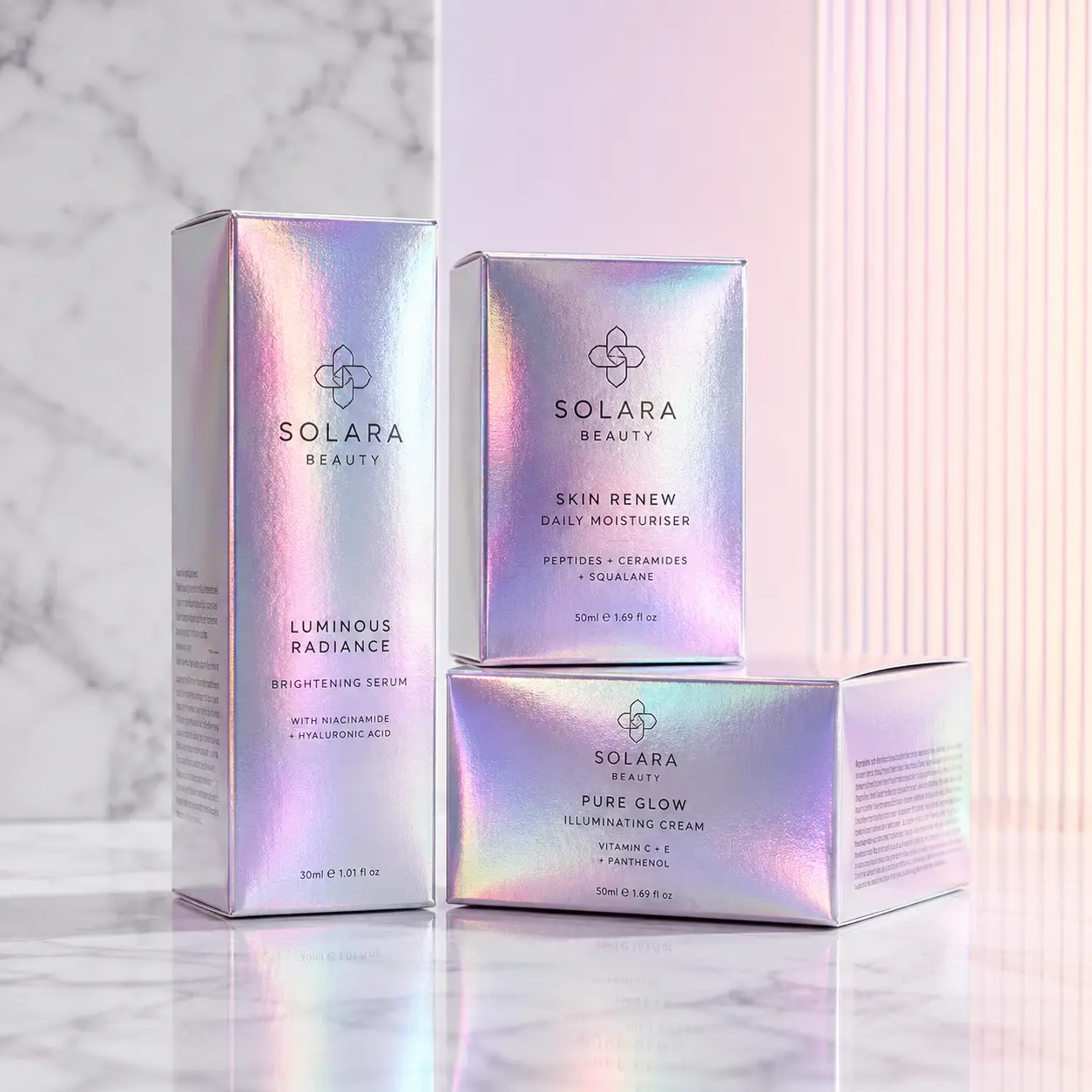 Solara Beauty holographic skincare packaging set featuring Luminous Radiance serum, Skin Renew moisturiser, and Pure Glow cream on marble surface