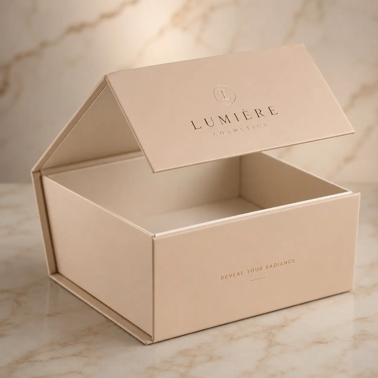 Luxury beige magnetic gift box with gold foil Lumière Cosmetics logo open on marble surface custom cosmetic packaging