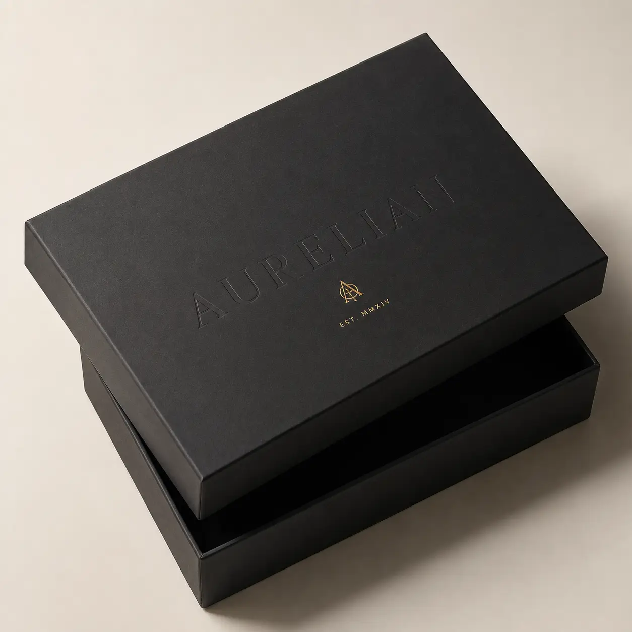 Luxury black matte rigid gift box with gold foil Aurelian logo, premium brand packaging design, elegant unboxing experience