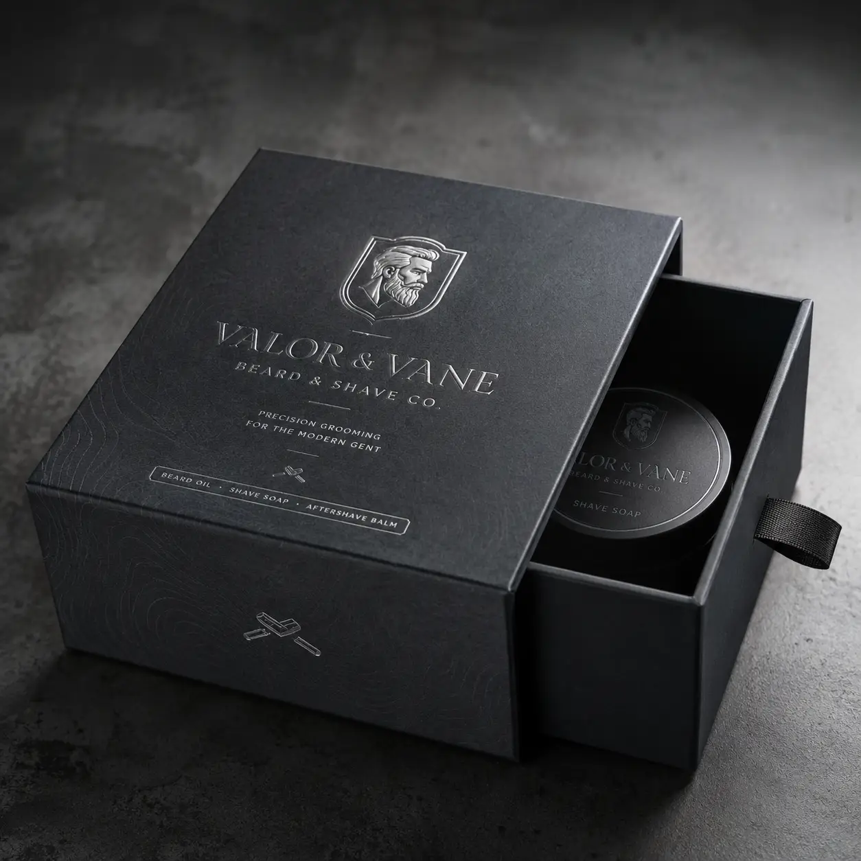 Luxury black drawer gift box packaging for Valor & Vane Beard & Shave Co with silver embossed logo and shave soap tin