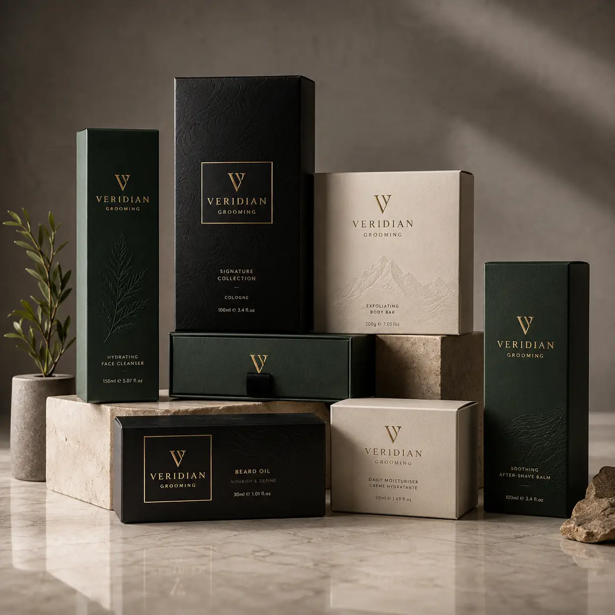 Luxury men's grooming packaging collection by Veridian in dark green, black and beige with gold foil branding on marble surface