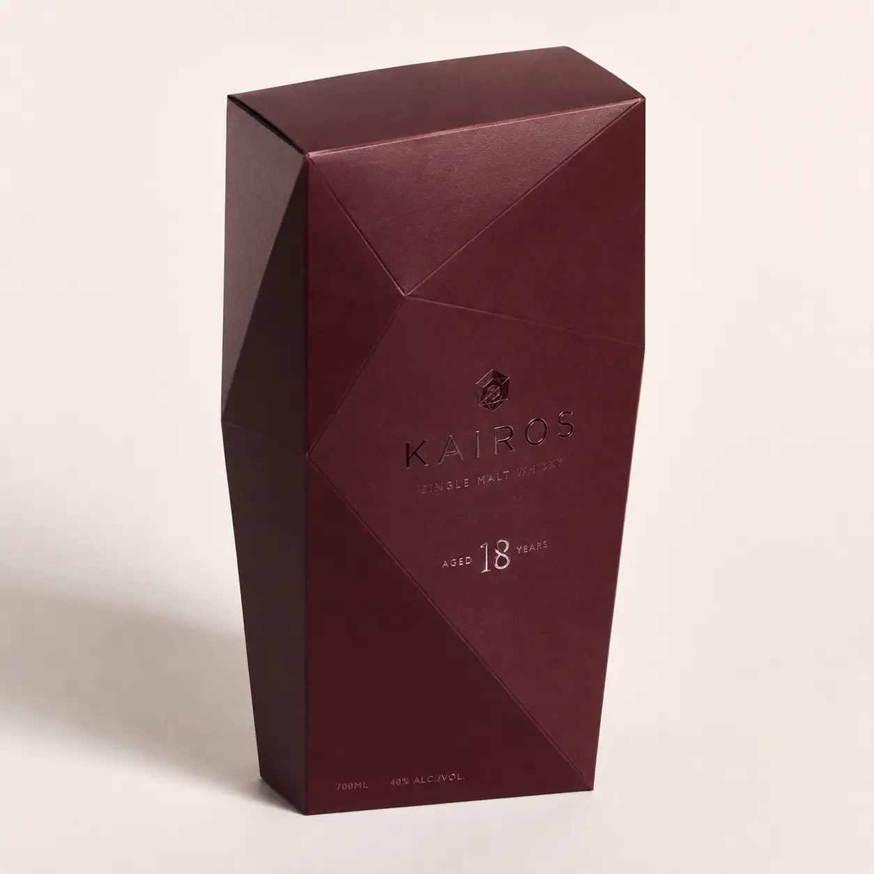 Deep burgundy geometric luxury whisky box packaging for Kairos 18-Year Single Malt, 700ml, premium angular design