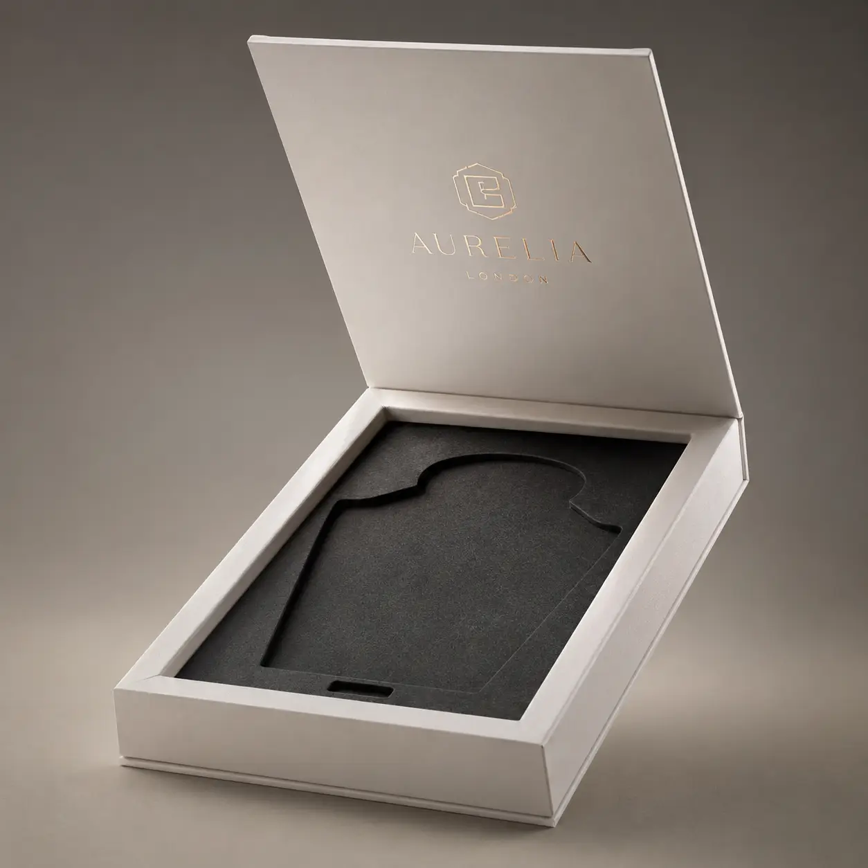 Aurelia London luxury white rigid gift box open revealing dark foam insert, premium branded packaging by The Packaging Masters