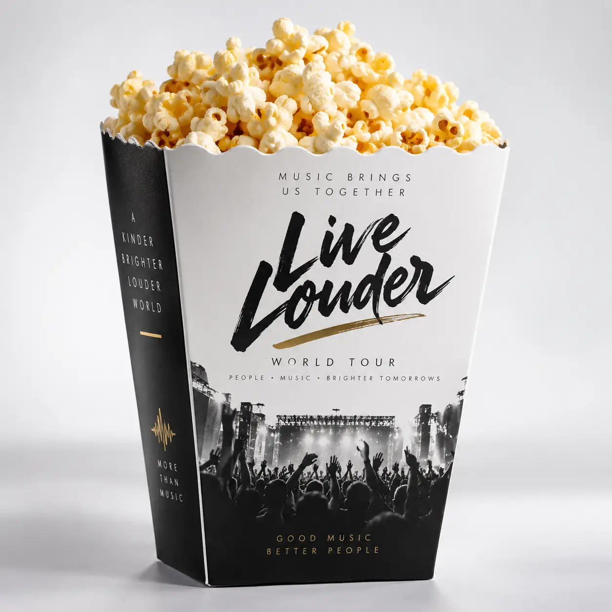 Black and white Live Louder World Tour custom popcorn box overflowing with buttered popcorn, gold accent branding, concert crowd design