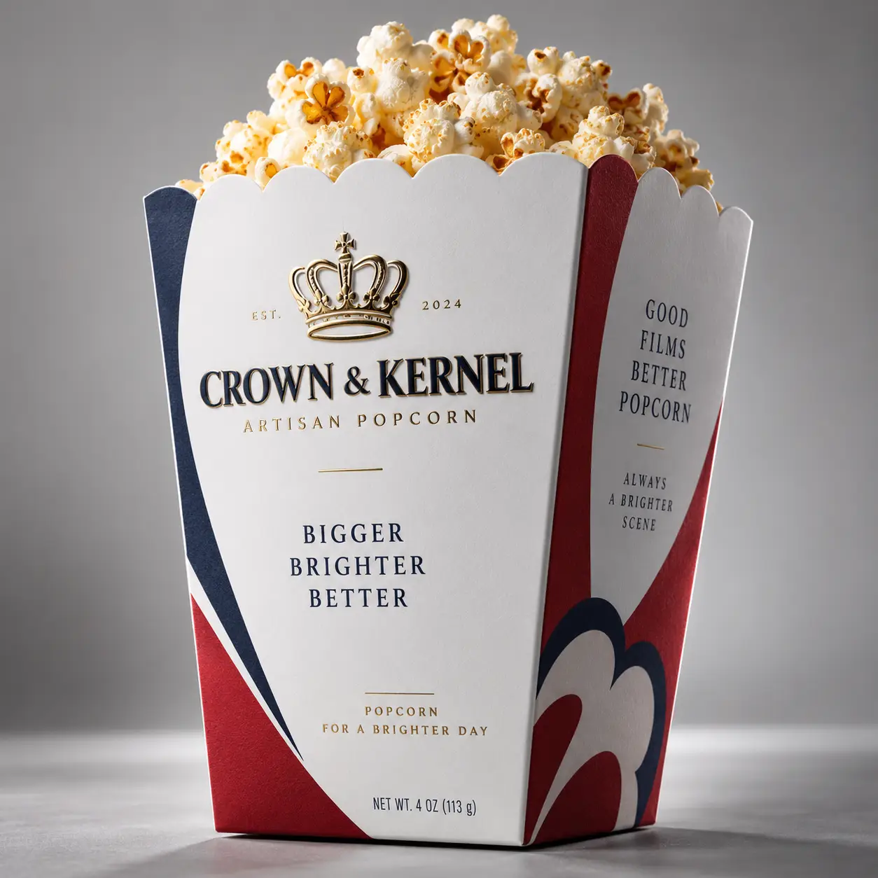 Crown & Kernel artisan popcorn box packaging in white, navy, red with gold crown logo, filled with fresh popcorn, elegant cinema branding