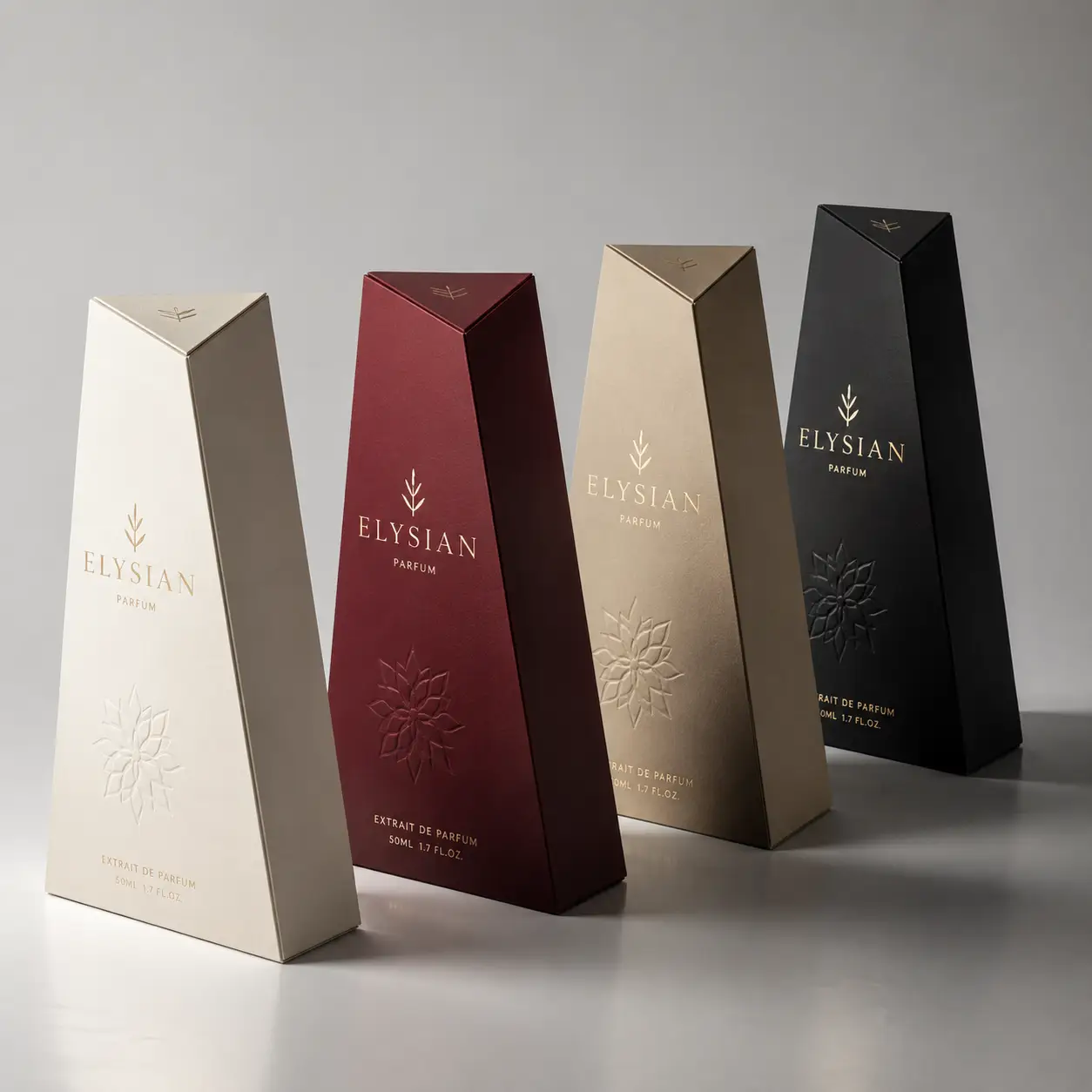 Four luxury Elysian Parfum Extrait de Parfum boxes in cream, burgundy, gold, and black with embossed floral details