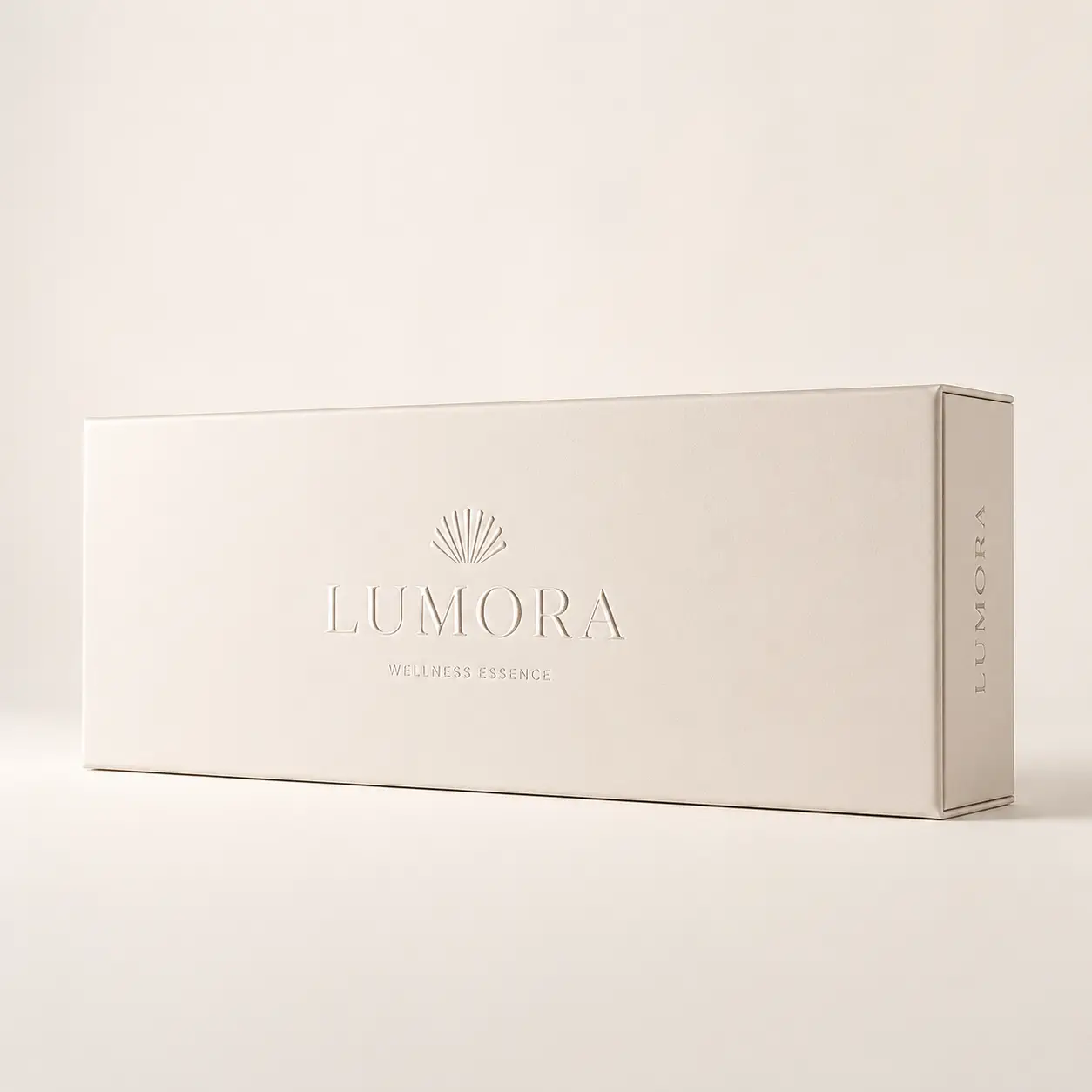 Lumora Wellness Essence luxury cream rigid gift box with embossed logo and shell motif on neutral background