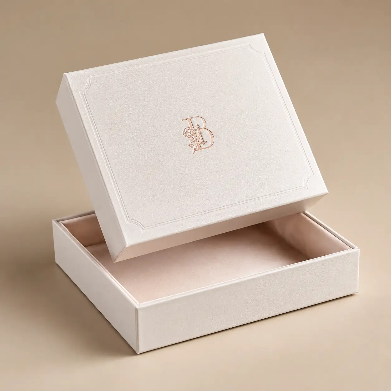 Elegant cream velvet luxury gift box with rose gold B monogram logo, open lid display, custom premium packaging design