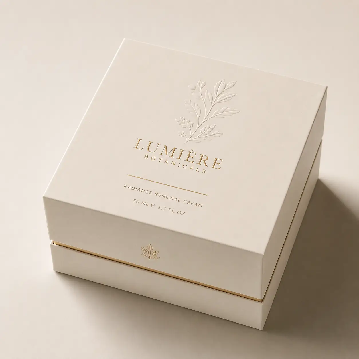 Luxury cream skincare box packaging with gold embossed botanical design, Lumière Botanicals Radiance Renewal Cream, elegant ivory rigid box