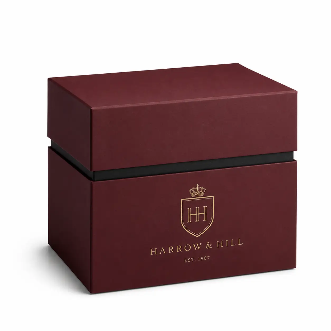 Luxury burgundy rigid gift box with gold Harrow & Hill crest logo EST. 1987, premium branded packaging with black accent trim