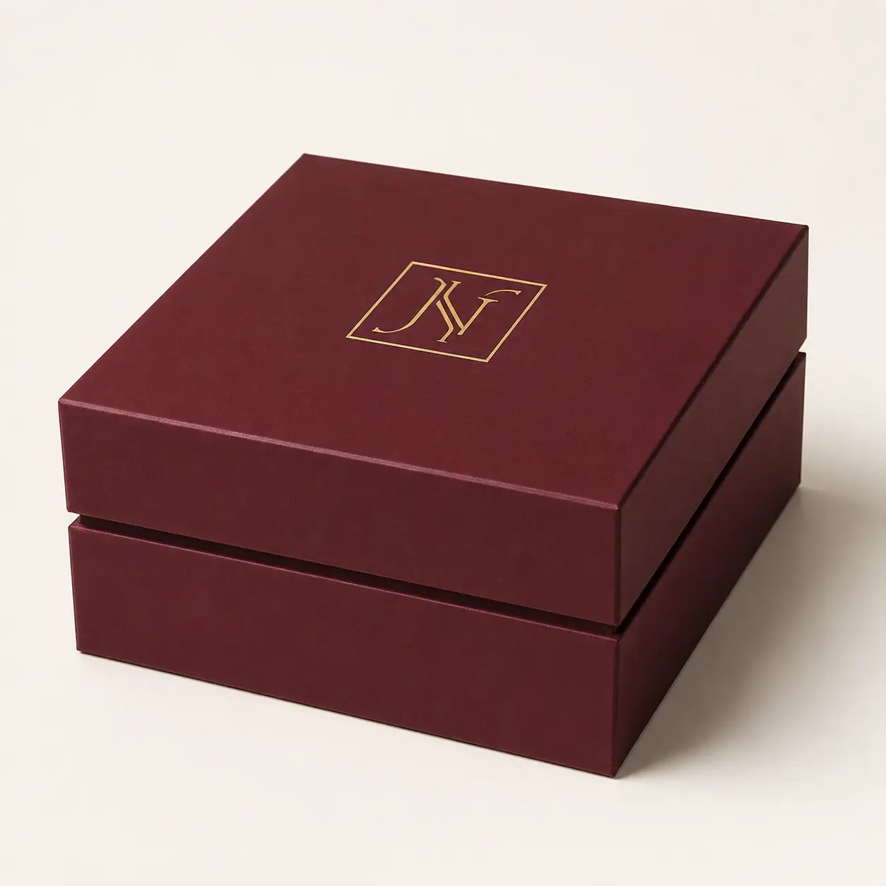Luxury burgundy rigid gift box with gold foil monogram logo, premium custom jewelry packaging by The Packaging Masters