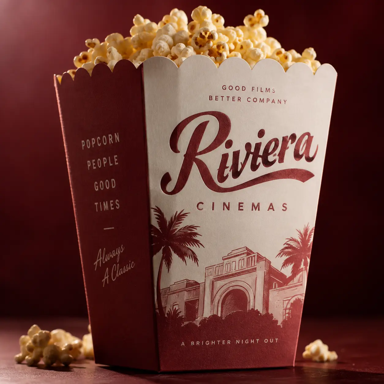 Riviera Cinemas vintage popcorn box packaging design in deep red and cream with palm tree illustration and retro typography