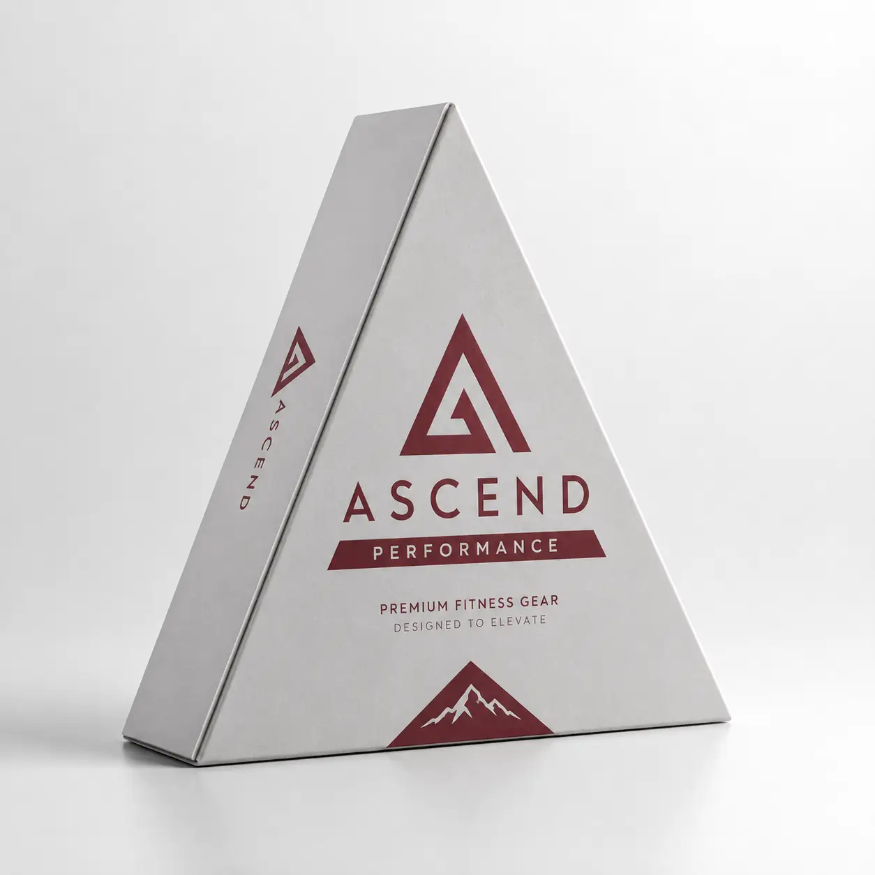 Triangular white premium fitness gear box with burgundy Ascend Performance logo and mountain graphic, custom packaging design