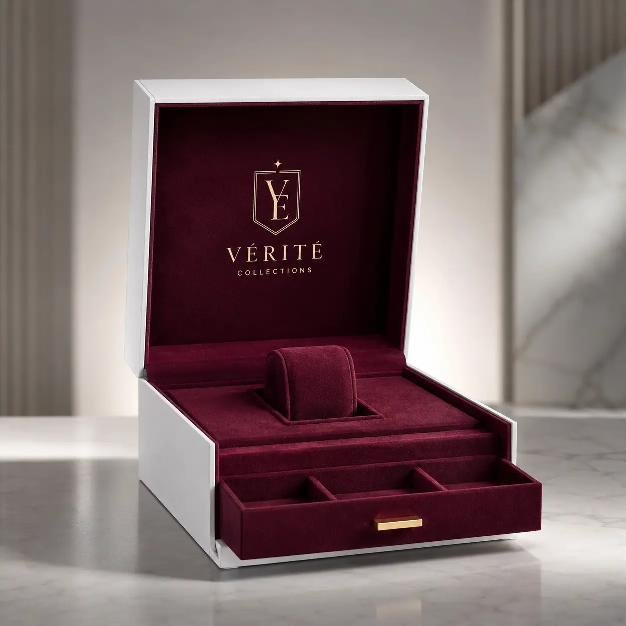 Luxury white jewelry box with burgundy velvet interior, gold Vérité Collections logo, ring holder, and pull-out drawer tray