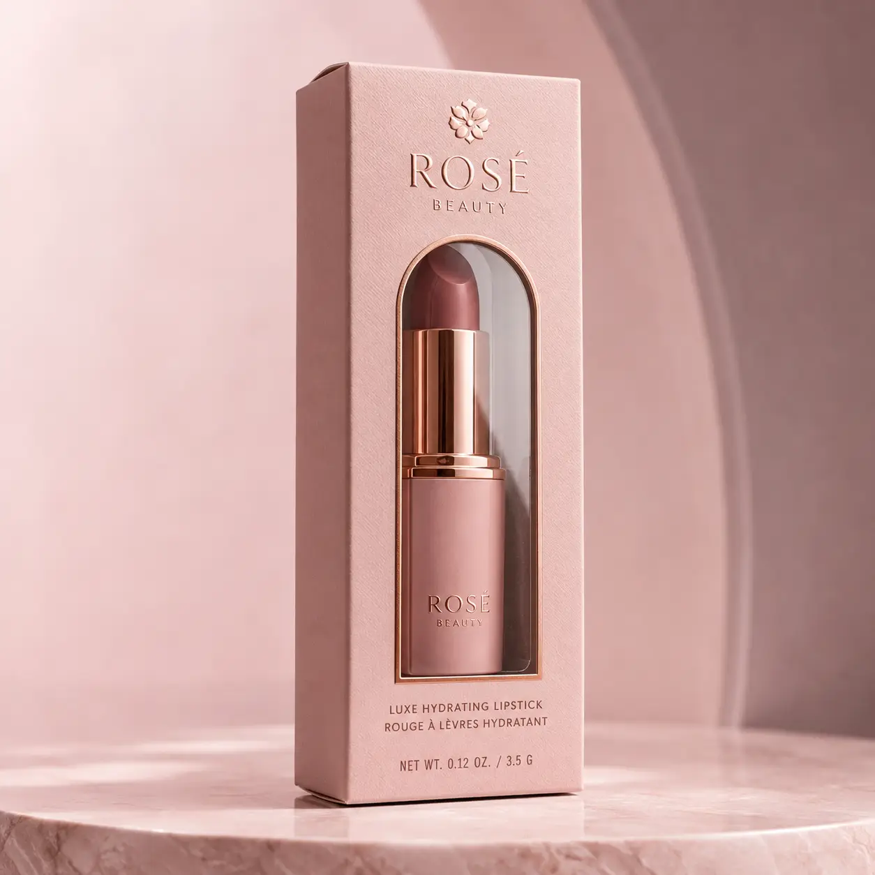 Rosé Beauty luxury lipstick packaging box in blush pink with rose gold accents, mauve bullet, elegant cosmetic product display