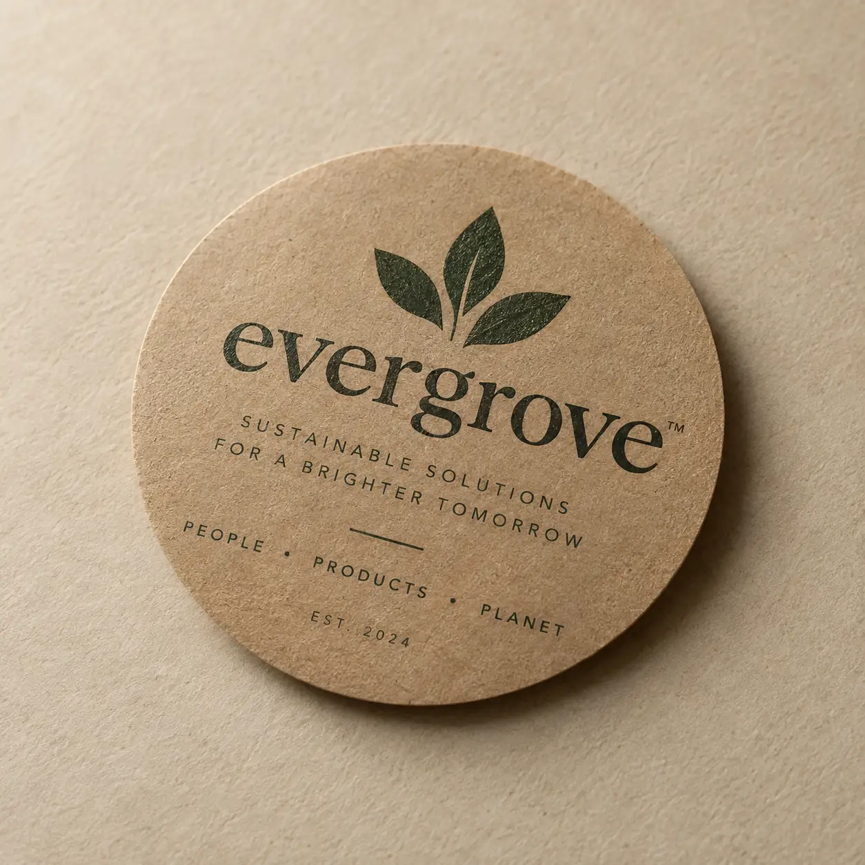 Round kraft paper coaster printed with Evergrove sustainable brand logo, dark green leaf icon, eco-friendly packaging design, EST. 2024